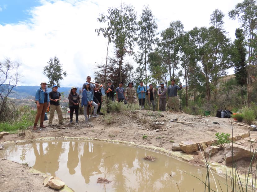 Image of a community of people by a lagoon.